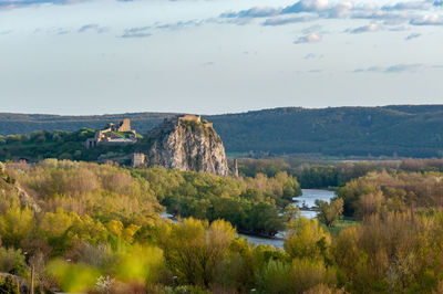 Scenic view of river and forest against sky