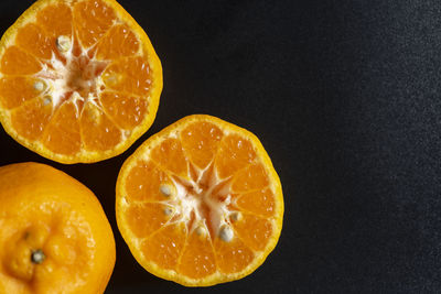 Close-up of orange slices on black background