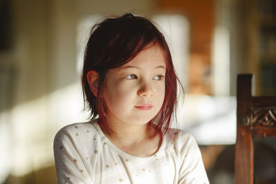 Portrait of girl looking away at home