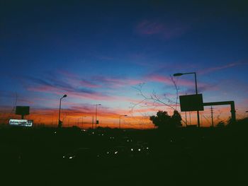 Silhouette trees against sky at sunset