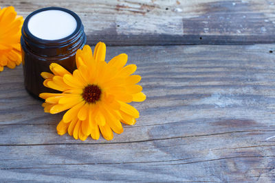 High angle view of yellow flower on table