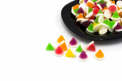 Close-up of multi colored candies against white background