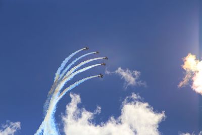 Low angle view of airplane flying against sky