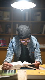 Man reading book in library