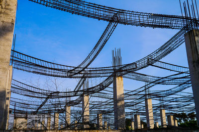 Low angle view of scaffolding against blue sky