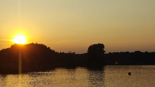 Scenic view of calm lake at sunset