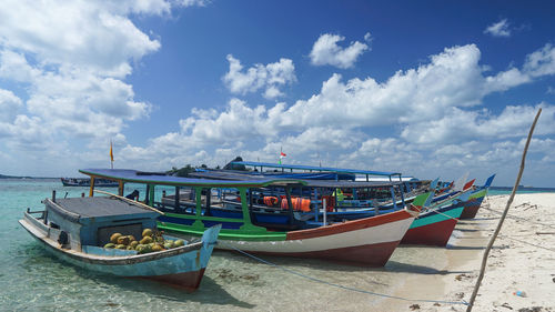 Boats moored on sea against sky