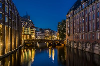 Canal passing through city at night