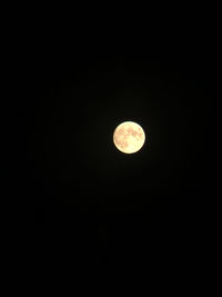 Low angle view of moon against dark sky