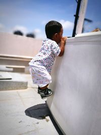 Toddler boy climbing on structure