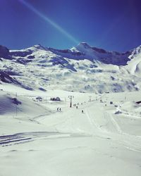 Scenic view of snowcapped mountains against clear sky