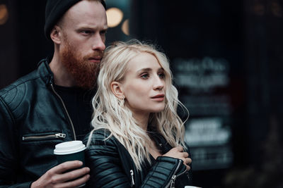 Portrait of young couple looking at camera