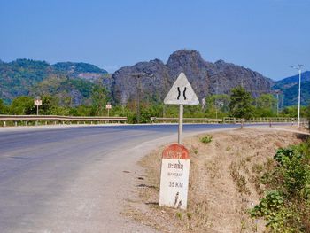 Road sign against clear sky