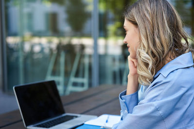 Young woman using laptop on table