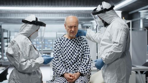 Rear view of female friends standing in factory