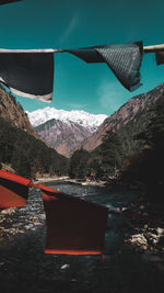 Boat moored on shore against mountains