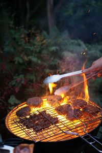 Close-up of bonfire on barbecue grill at yard