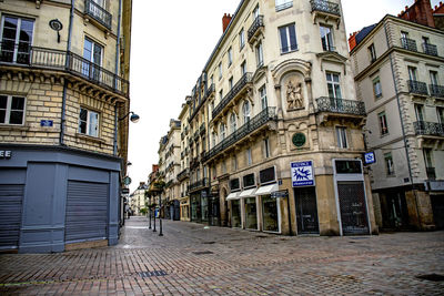 Street amidst buildings against sky in city