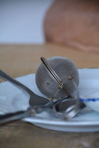 Close-up of empty plate and tea strainer