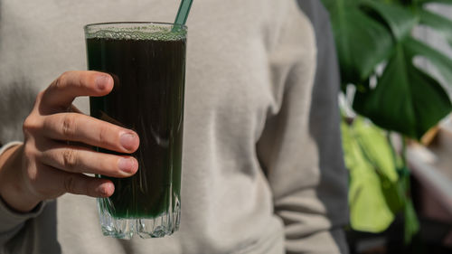 Midsection of man holding drink