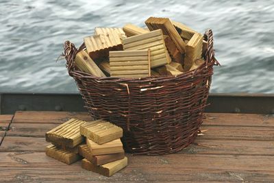 Wooden blocks in basket on pier over lake