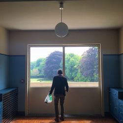 Woman standing on tree trunk
