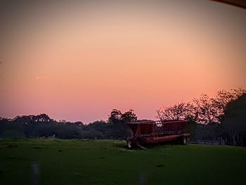 Scenic view of field against sky during sunset