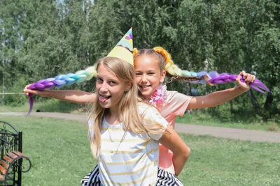 Teenager girl and her little friend selebrating birthday. girls having fun outdoors party. 