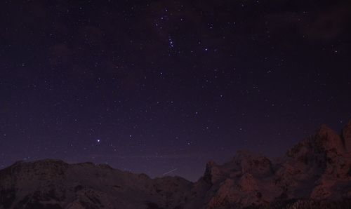 Low angle view of mountain against sky at night