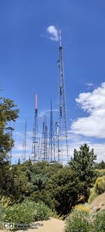 Low angle view of communications tower against sky