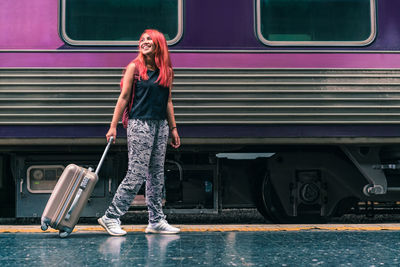 Full length of woman standing on train