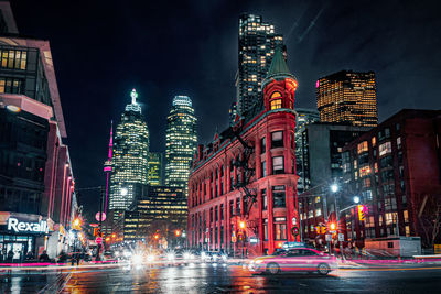 Illuminated city street and buildings at night