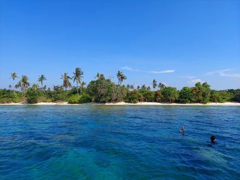 Scenic view of sea against clear blue sky