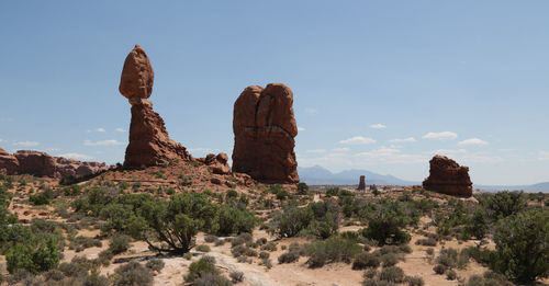 Rock formations on landscape against sky