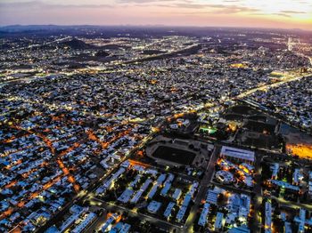 High angle view of illuminated city buildings against sky