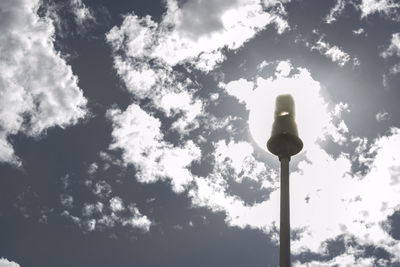 Low angle view of street light against cloudy sky