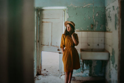 Girl in old derelict building with hat on