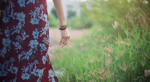 Midsection of woman standing by plants