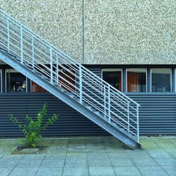 Metal staircase against building 