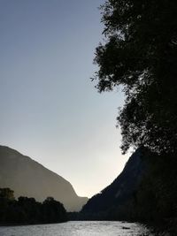 Scenic view of lake and mountains against clear sky