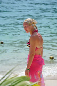 Young woman standing on sea shore