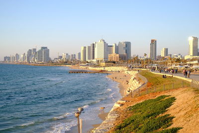 Panoramic view of sea and buildings against clear sky