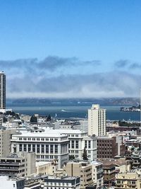 View of cityscape against blue sky