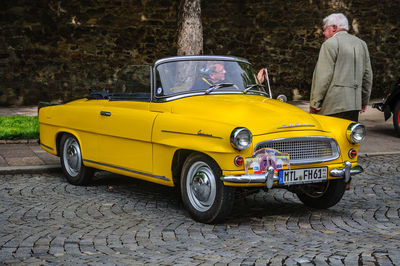 Yellow vintage car on street in city