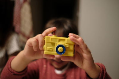 Close-up of boy playing with toy at home