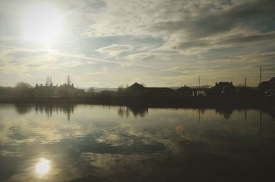 Scenic view of lake against sky at sunset