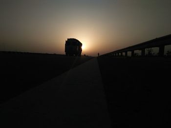 Silhouette bridge against sky during sunset