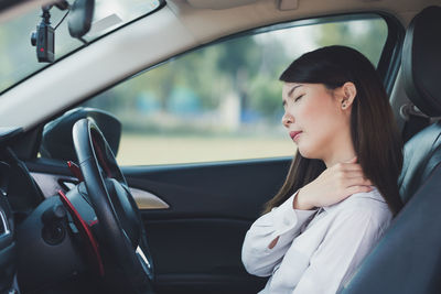 Young woman driving car