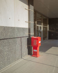 Red umbrella on wall of building