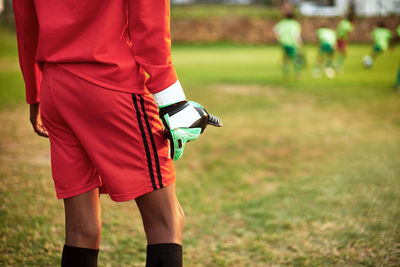 Midsection of woman standing on field